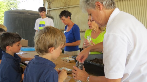 Grace Academy kids making self watering containers