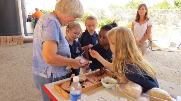 Grace Academy kids spinning cotton with Carolyn
